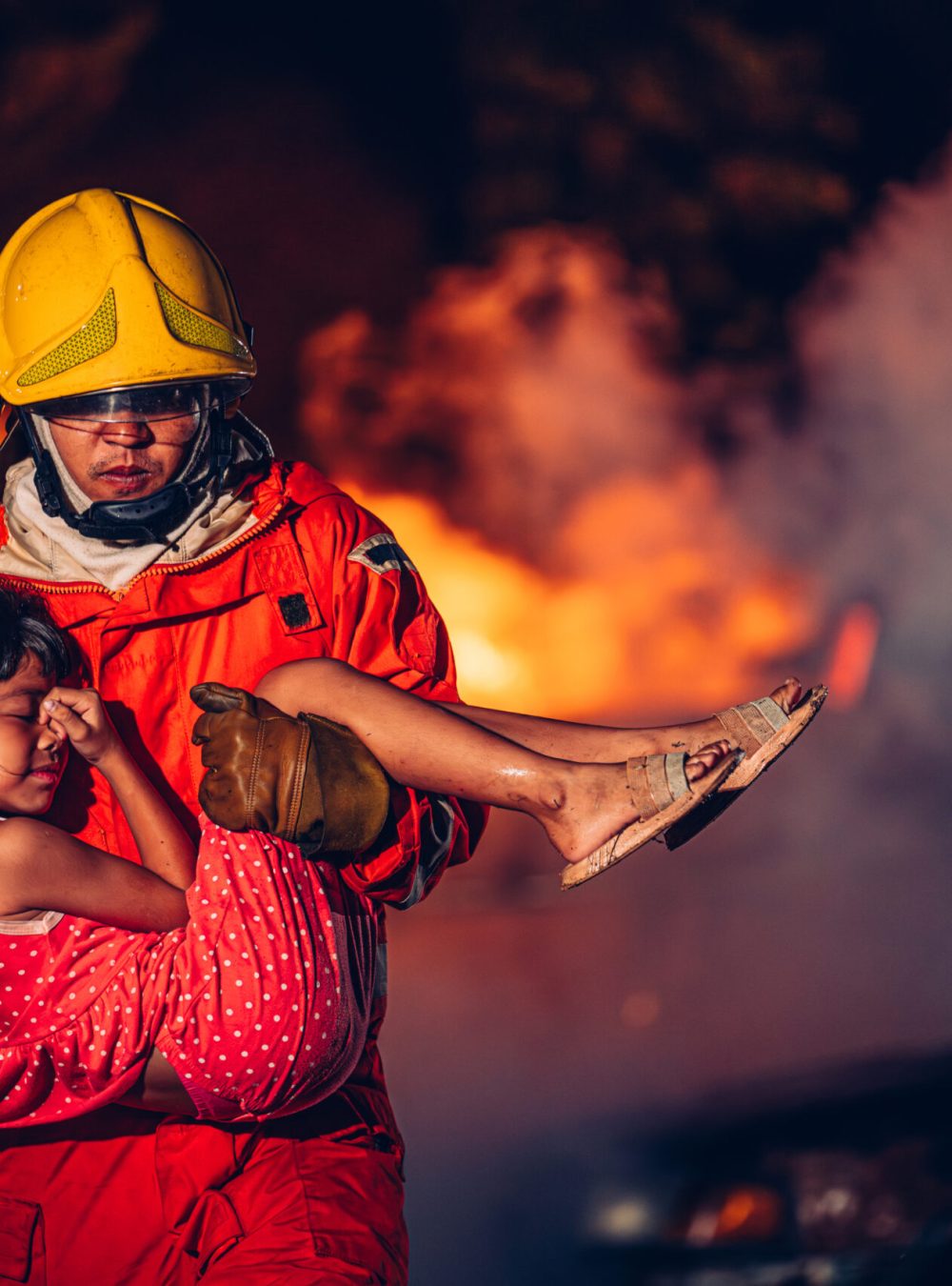 Firefighter in Action, Protecting People from Fire and Smoke. Fearless Firefighter Rescues Girl from Raging Fire and Smoke. Brave Firefighters Save Lives in Danger.